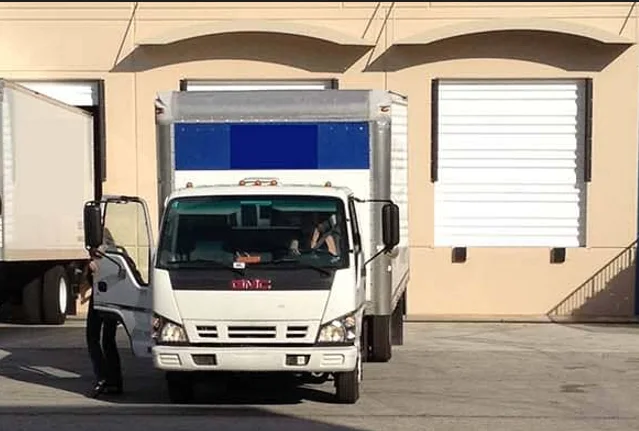Antique shipping truck at a loading dock