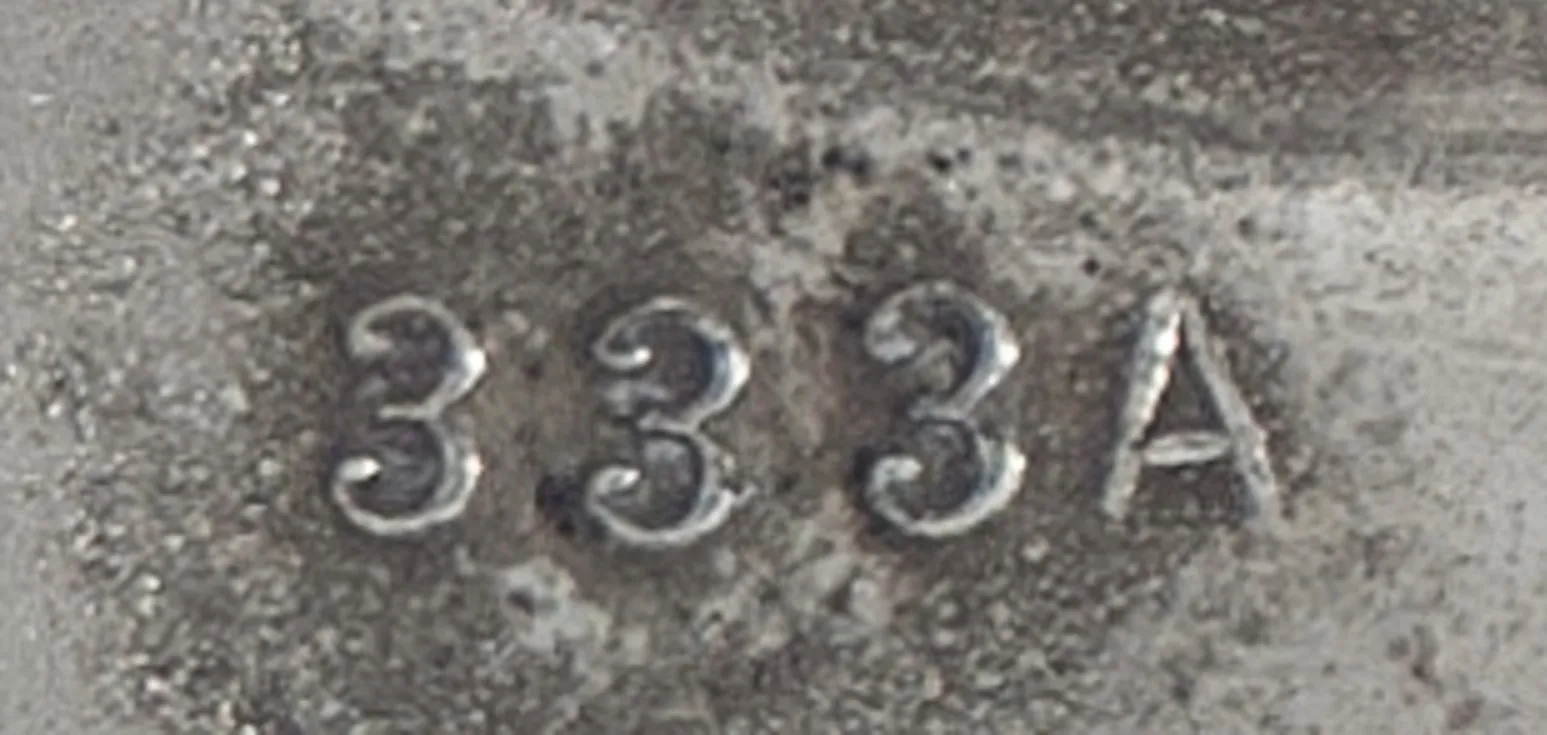details of an antique serial number 333 A in relief