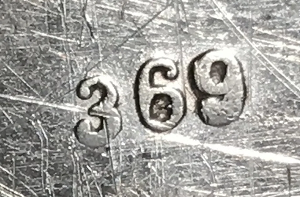 Serial number 369 visible on antique surface