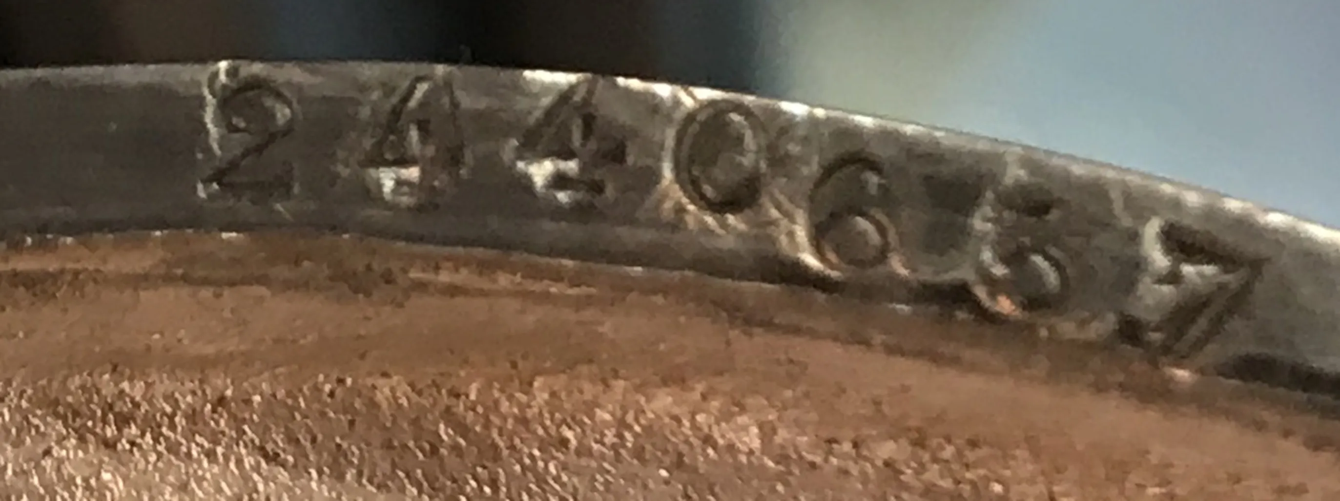 Antique inscription displaying serial number 2440657, featuring visible details and historical context.