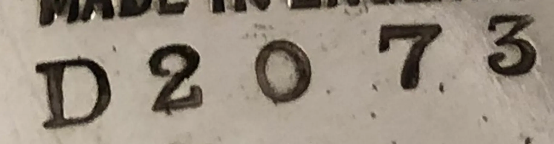 antique mark featuring serial number D 2073 on plain background