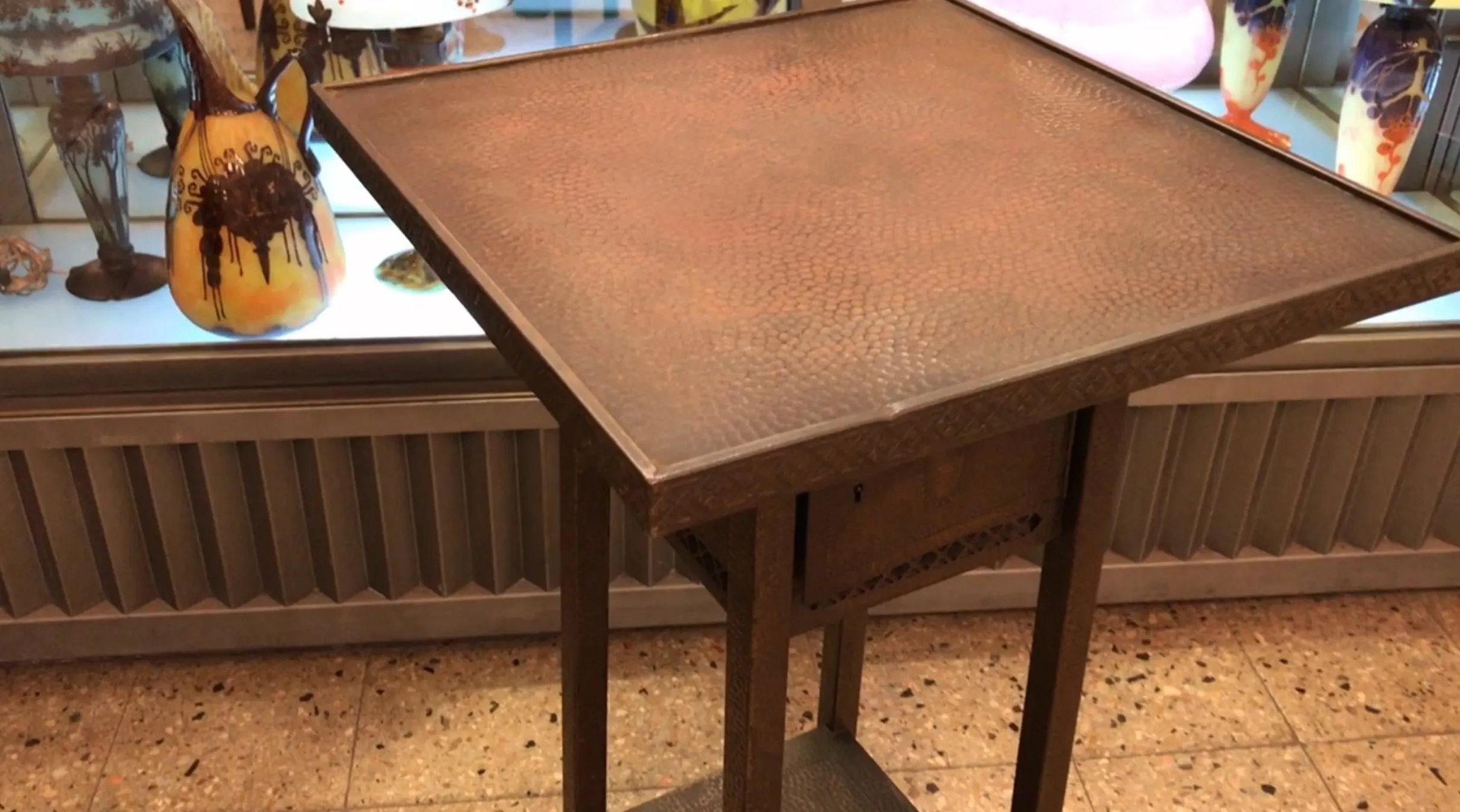 antique small table with decorative design and colorful environment