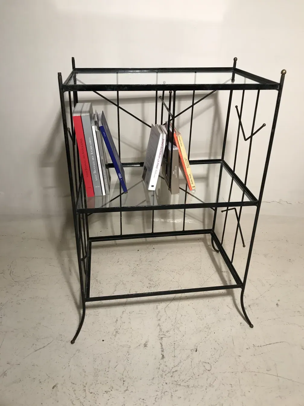 antique bookcase with slanted shelves and books displayed