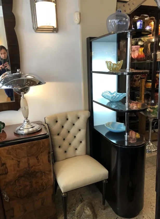 Antique bar cabinet with glass shelves and decorative design