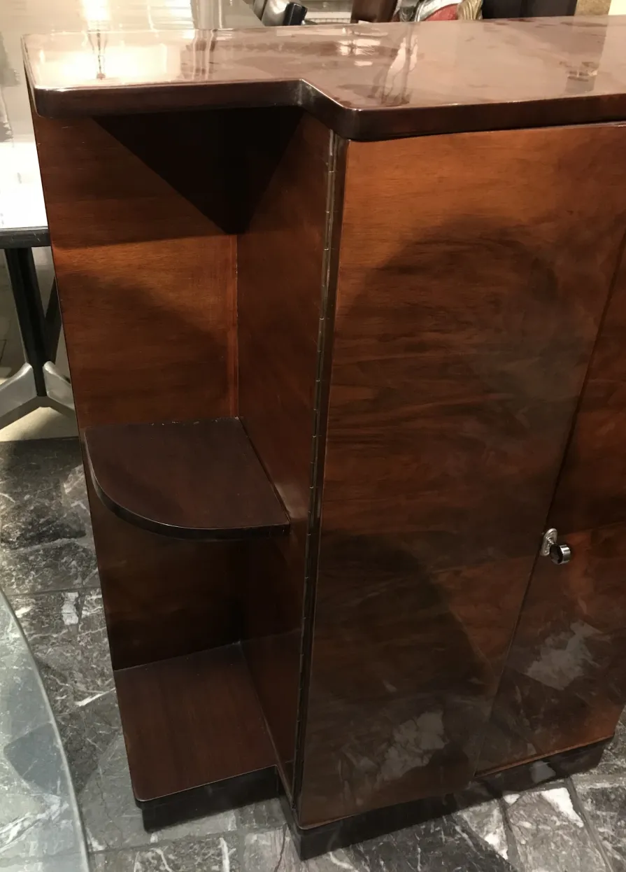 Antique wooden bookcase with curved shelves.