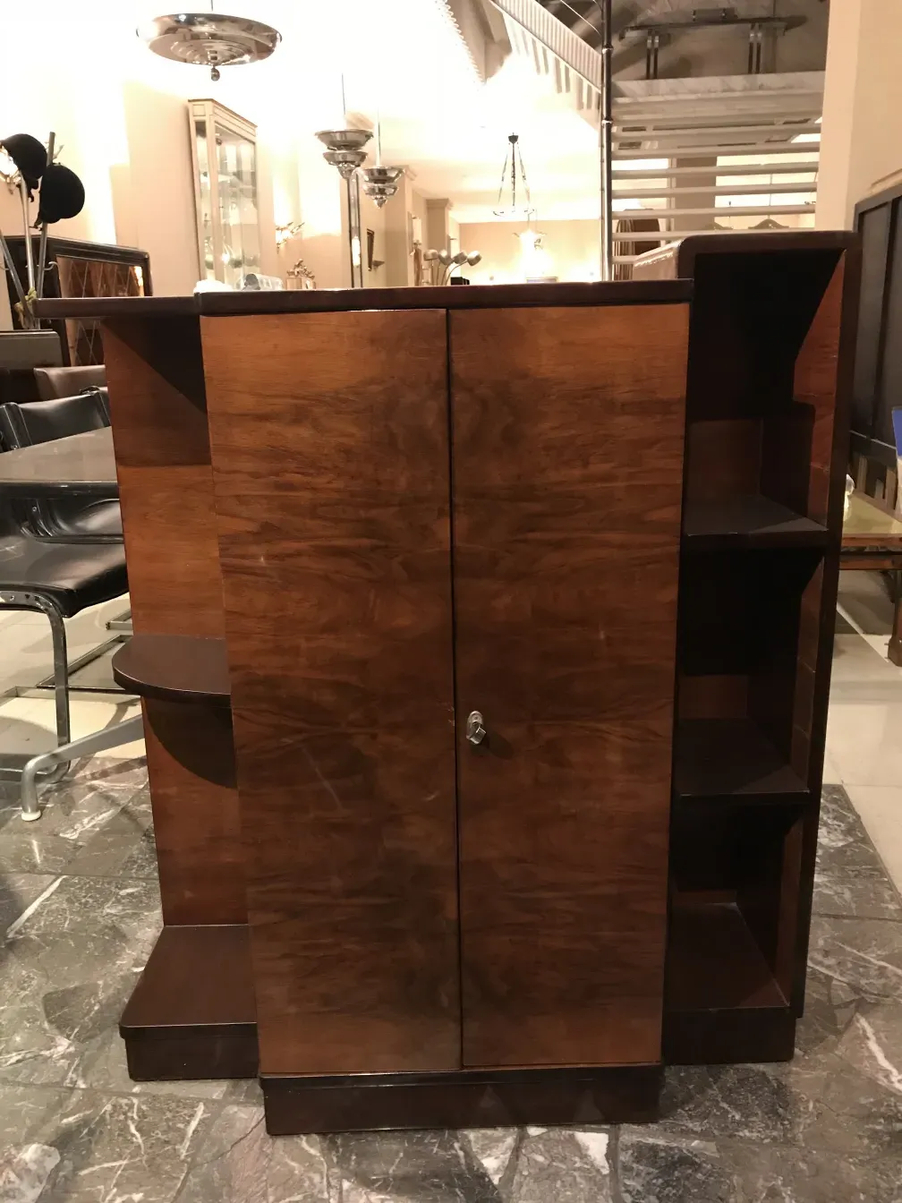 Antique bookcase with visible shelves, decorative design.