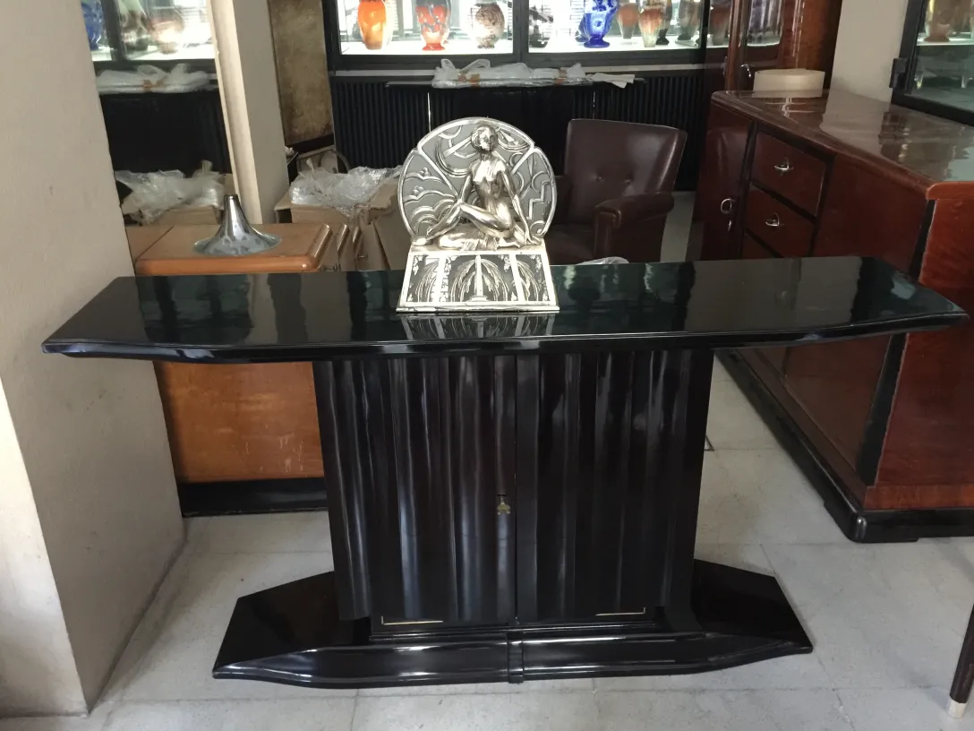 two vintage console tables with decorative accents in an elegant setting