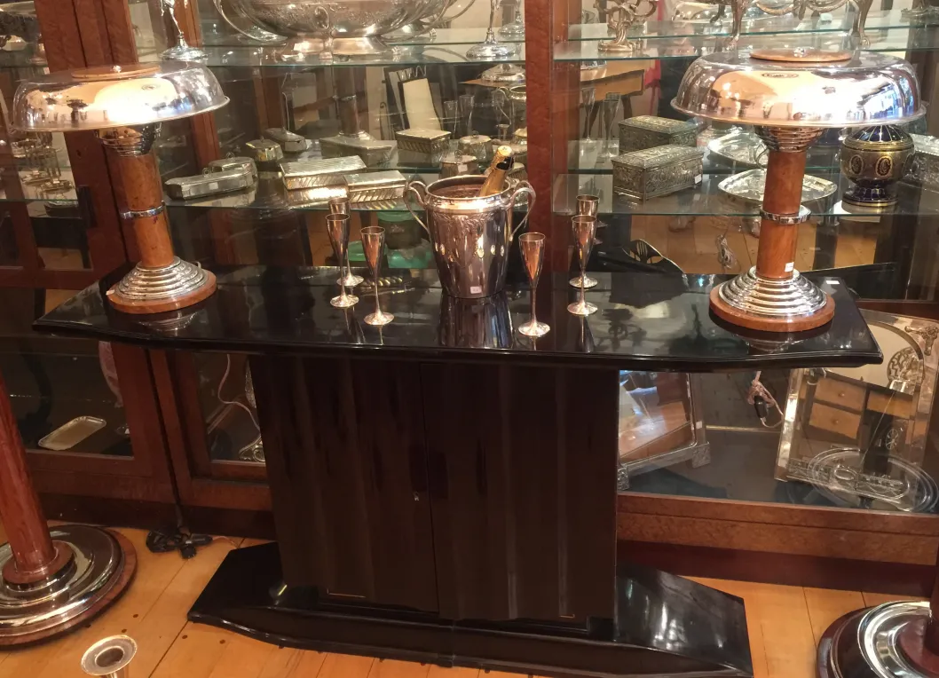 two antique consoles in an elegant setting with lights