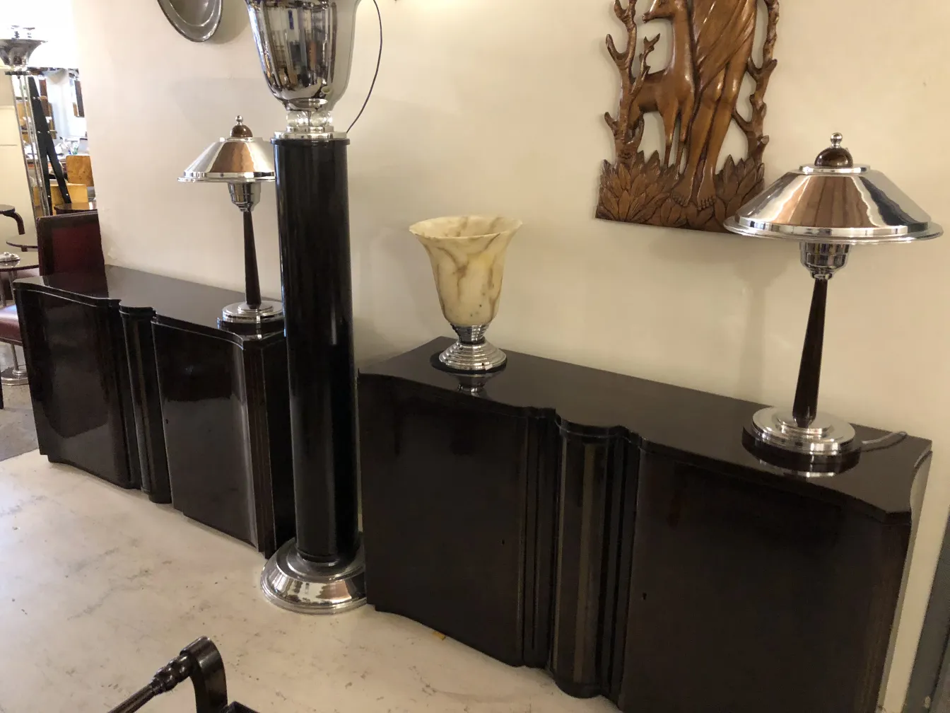 two antique consoles with decorative lamps