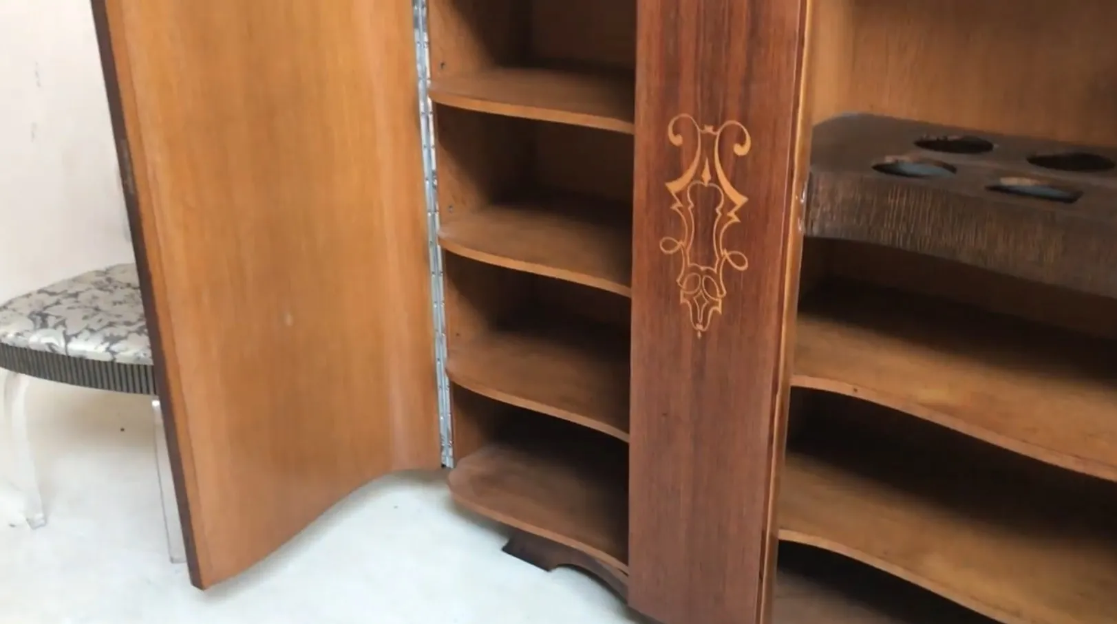 antique bookcase with multiple visible shelves and decorative details