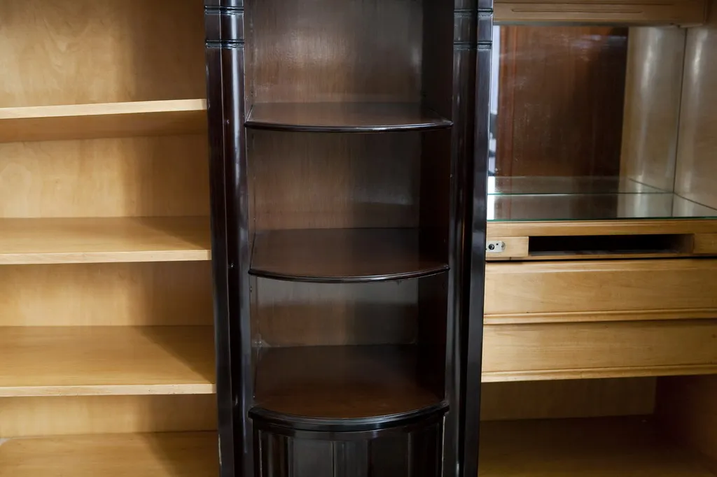 antique bookcase with curved shelves, classic setting