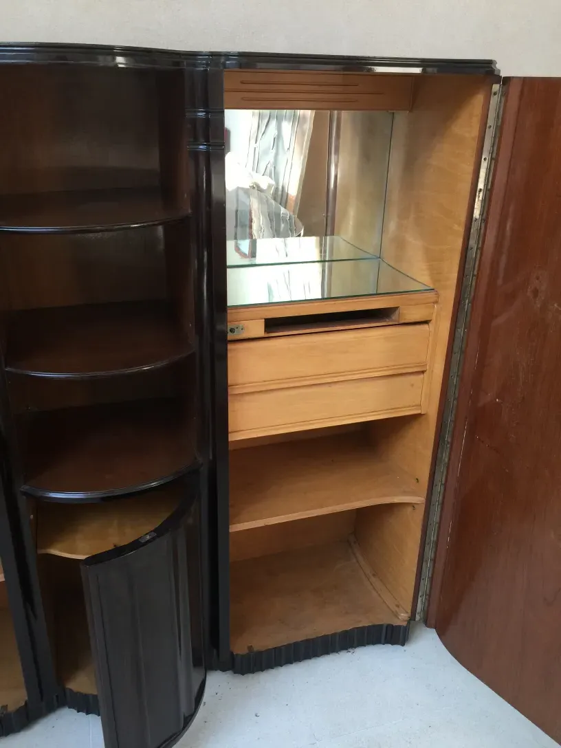 antique bookcase with glass shelves and light wood in a cozy setting.