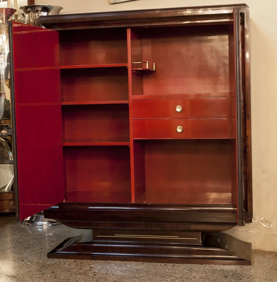 antique bookcase with red shelves and two golden drawers, stylish and functional