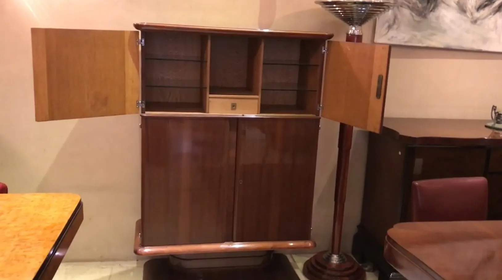 Antique bookcase with alcove, light background and open doors.