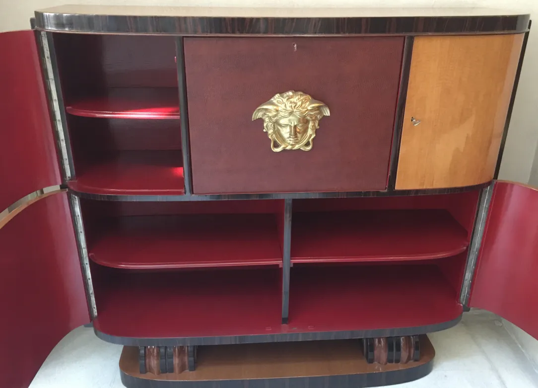 Antique bookcase with red shelves and gold decoration