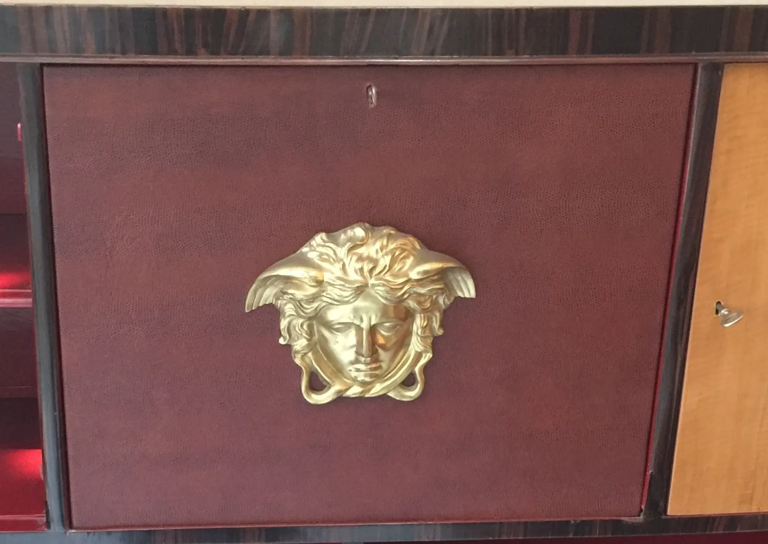 antique bookcase with elegant design featuring a golden face