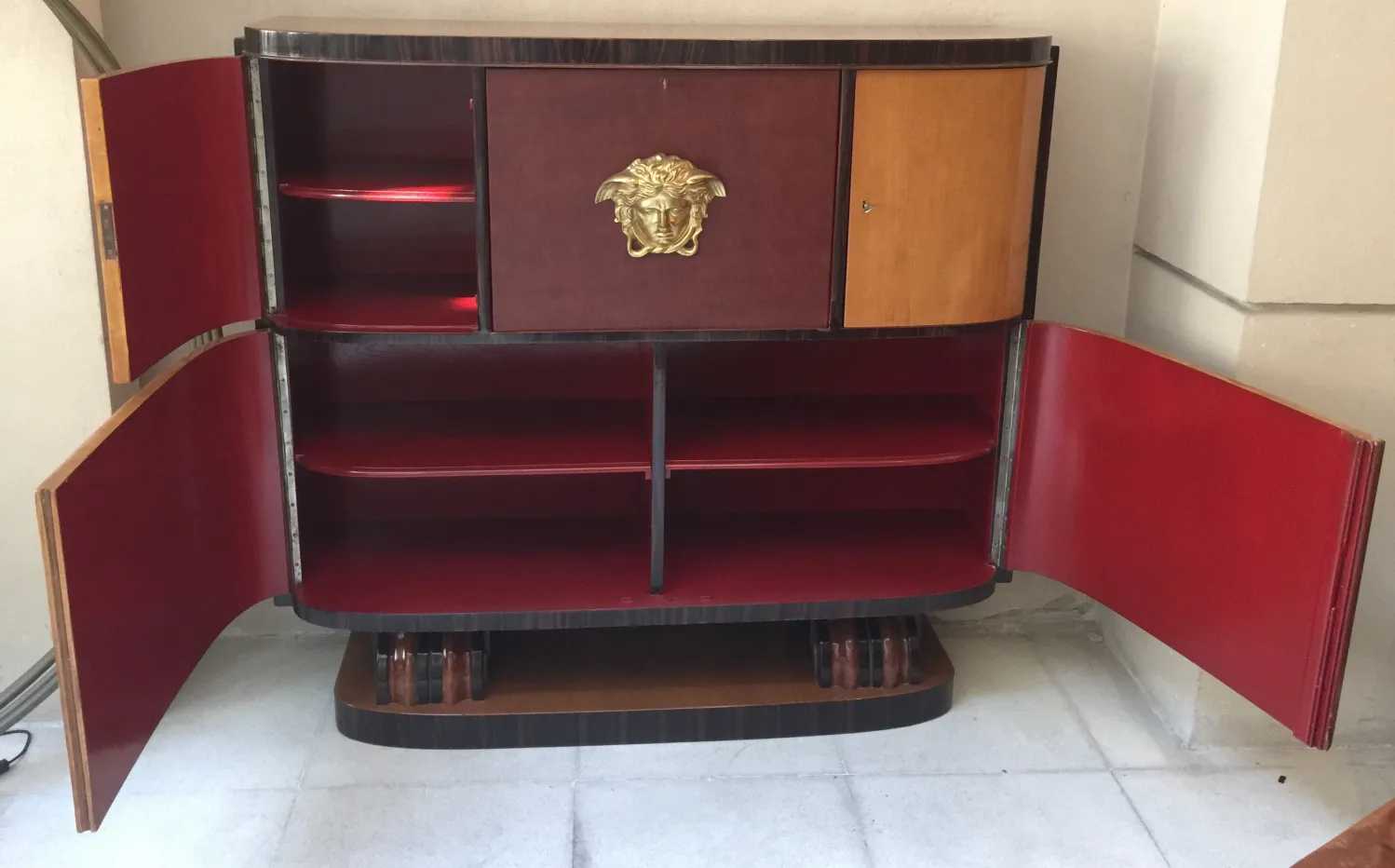antique bookcase featuring decorative shelves and elegant finishes