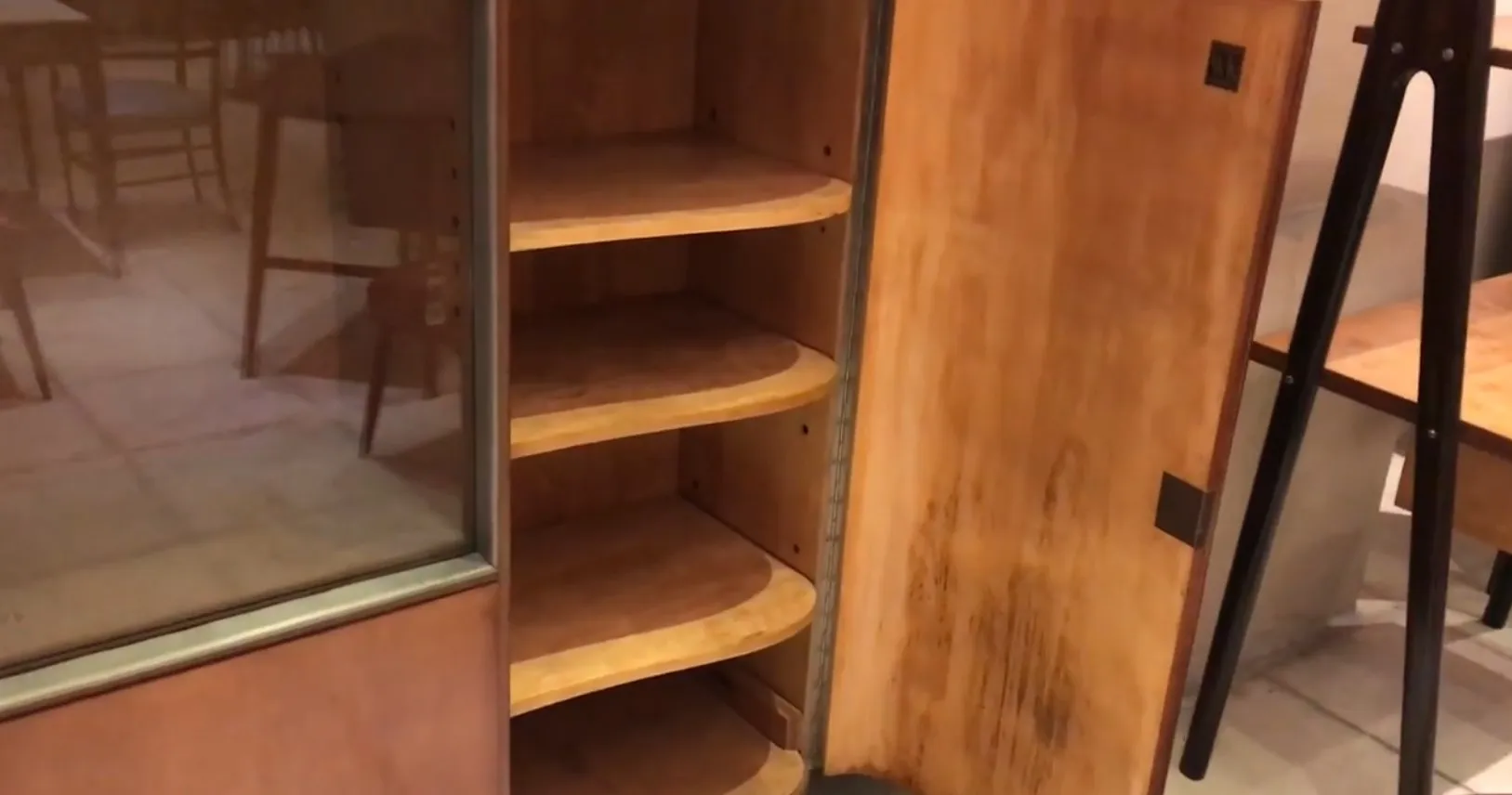 Antique bookcase with curved shelves, cozy environment