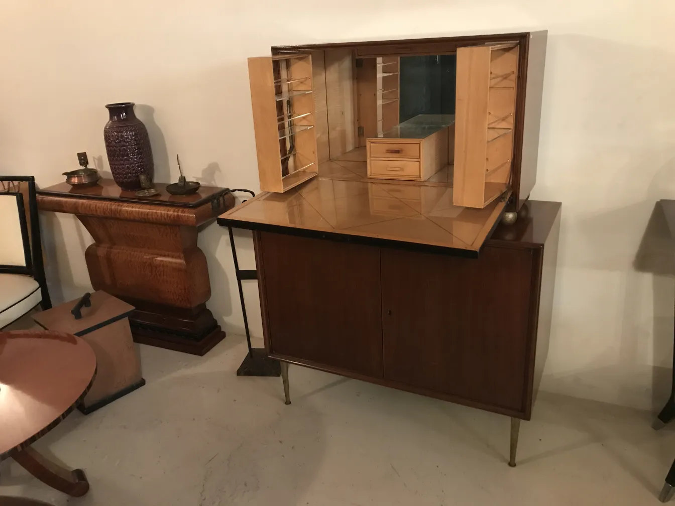 Antique bar cabinet with interior compartments and elegant style.
