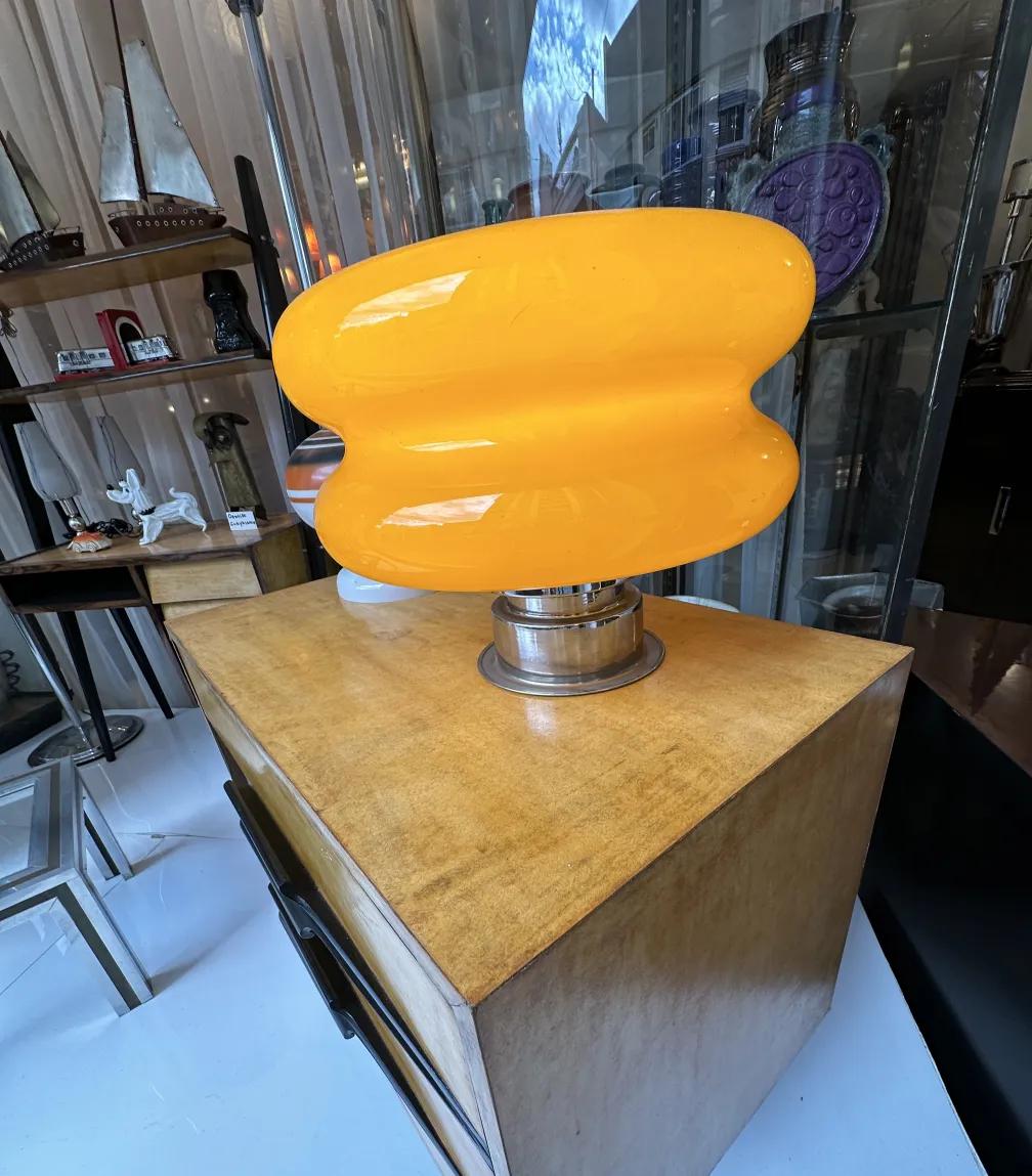 antique bedside table with decorative orange lamp