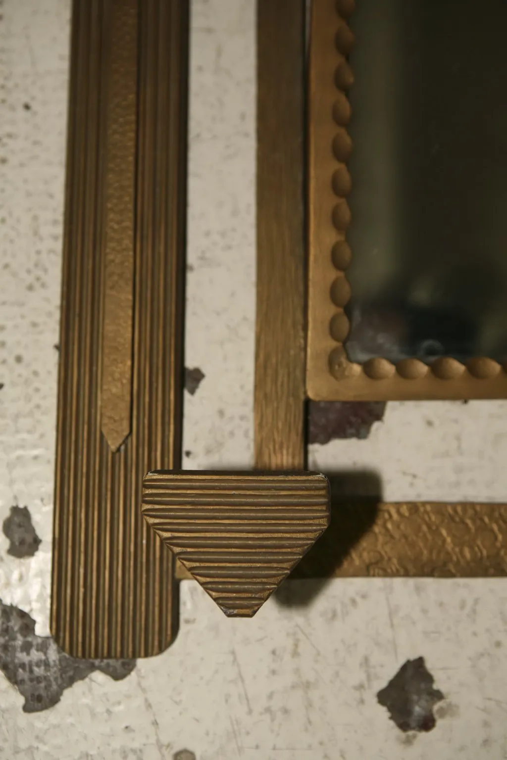 Antique coat rack with elegant golden design in a classic setting.