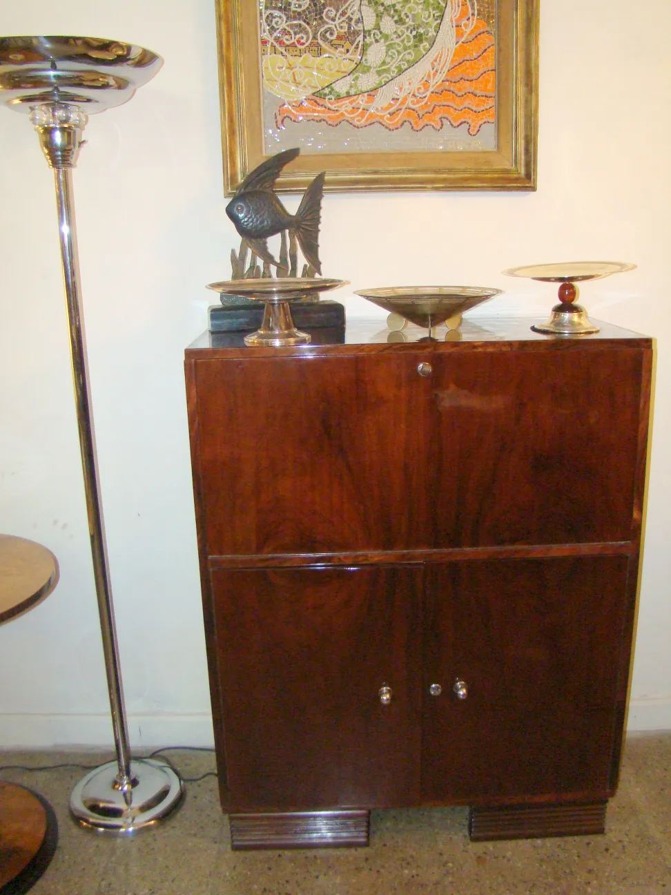 Antique wooden desk, vintage decor and elegant ambiance. Next to a floor lamp.