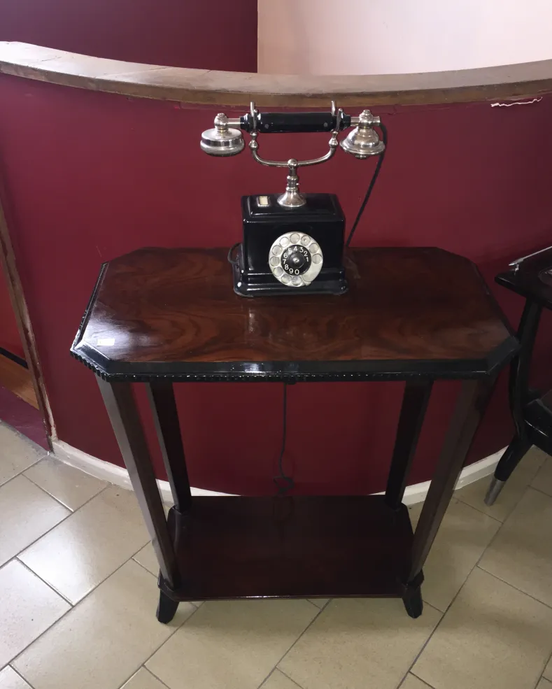 antique small table with a phone, cozy atmosphere, brown color