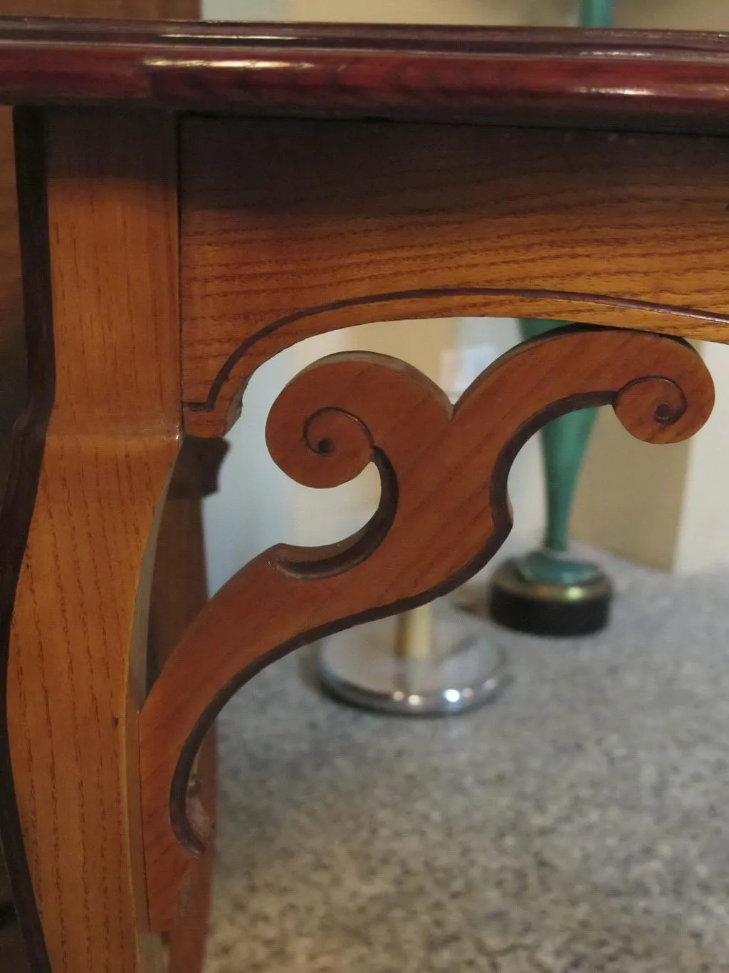 Antique table with elegant details by émile gallé in a neutral background.