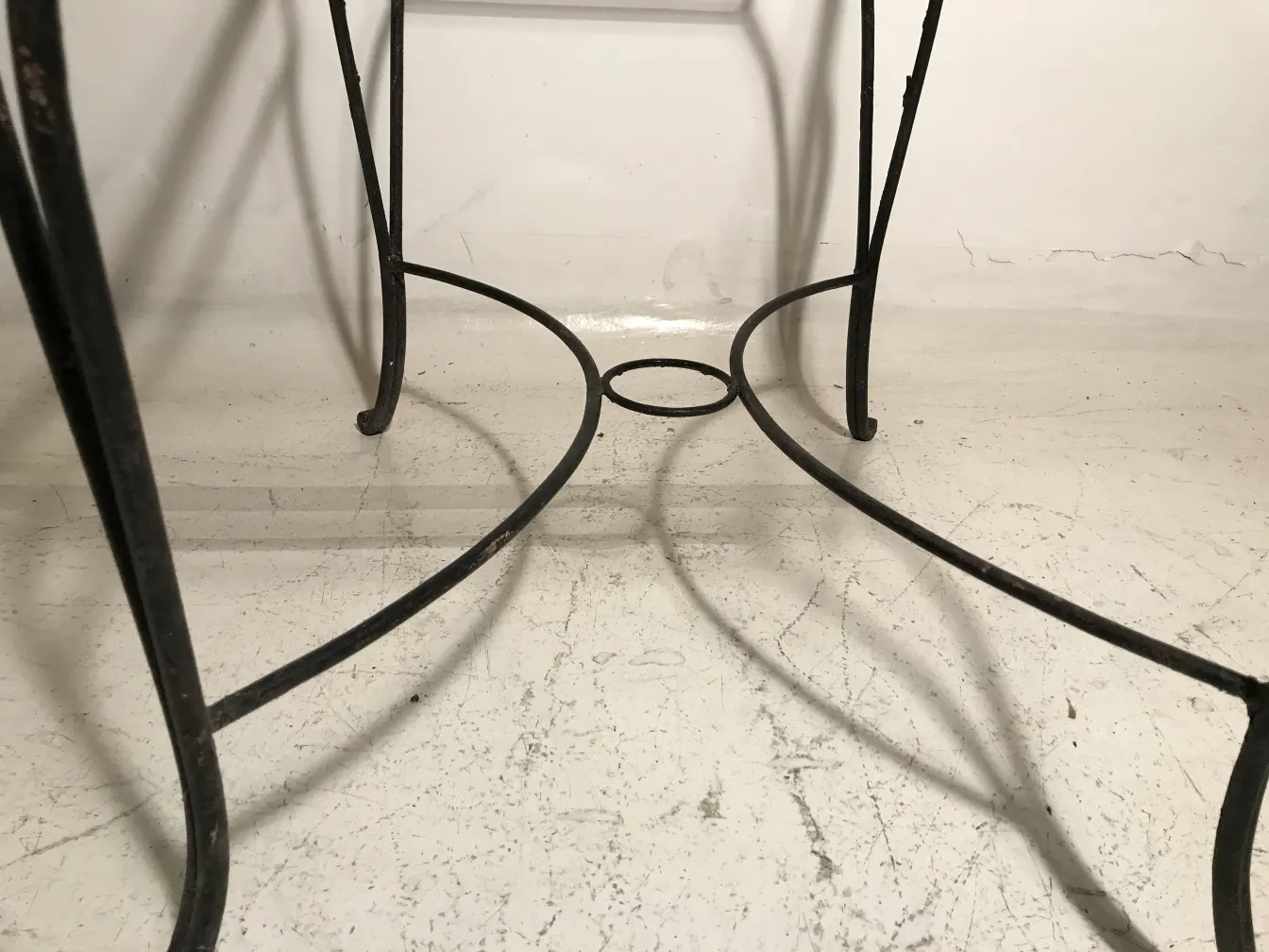 View of antique garden table base with curved details