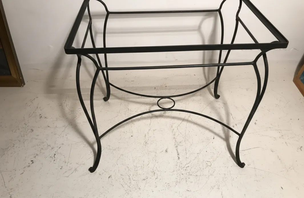 antique garden table with curved legs and circular detail