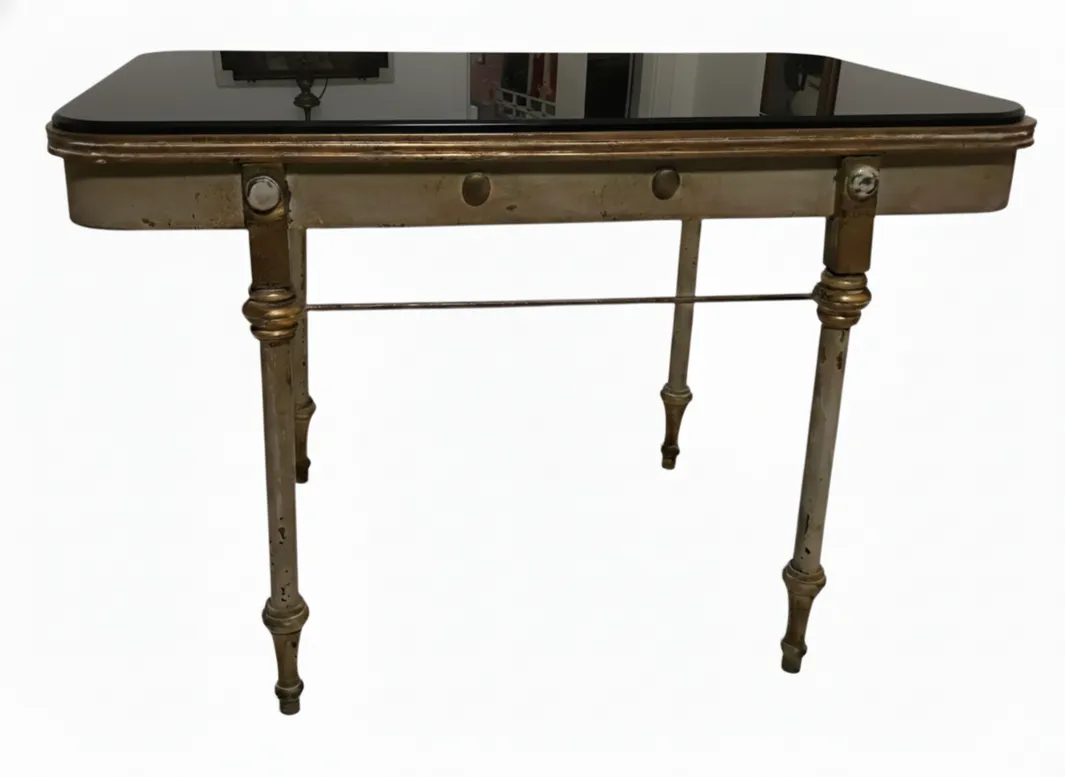 Antique garden table with decorative legs and an elegant surface.