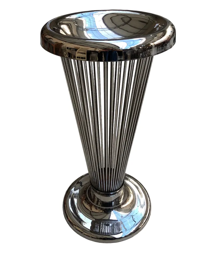Antique standing ashtray with elegant shape and shiny finish in a decorative setting