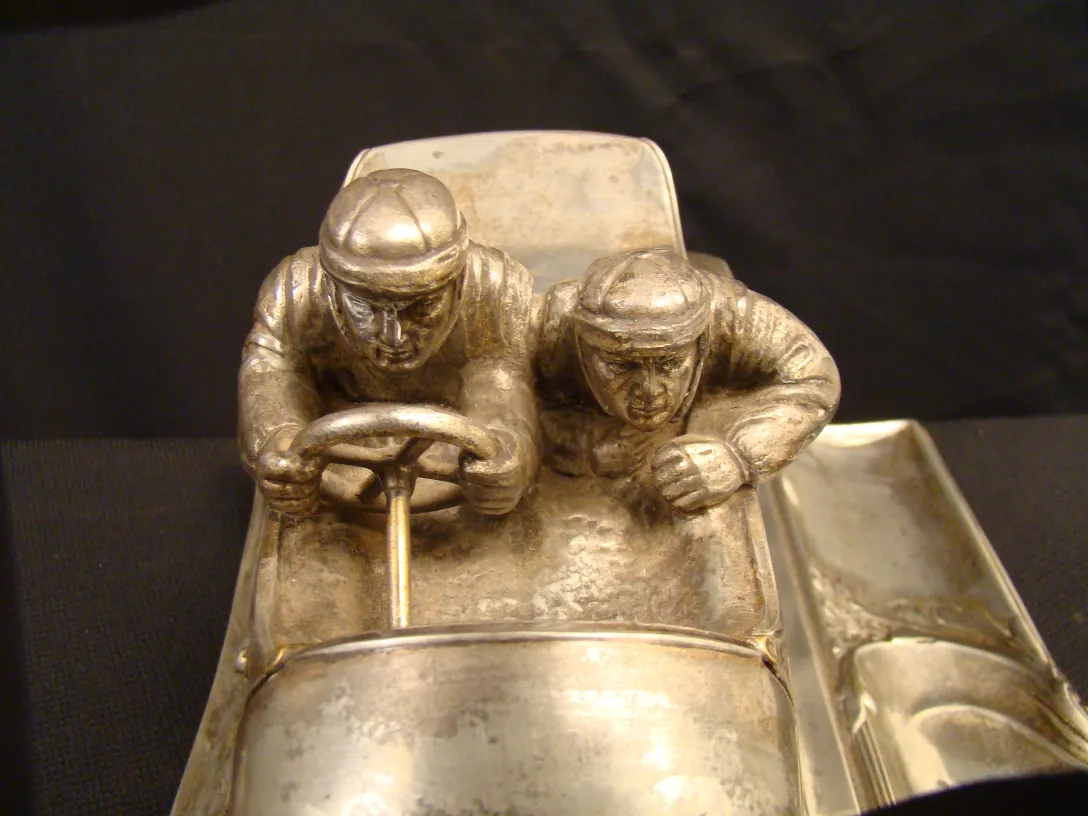 Antique WMF inkwell featuring two drivers in a car.