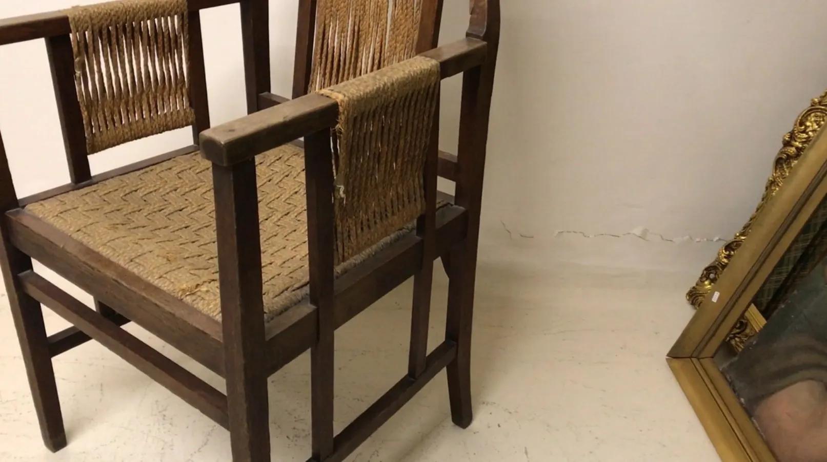 antique desk chair with woven seat, neutral background