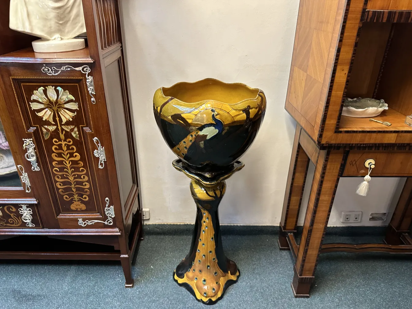 antique planter with colorful design and pedestal
