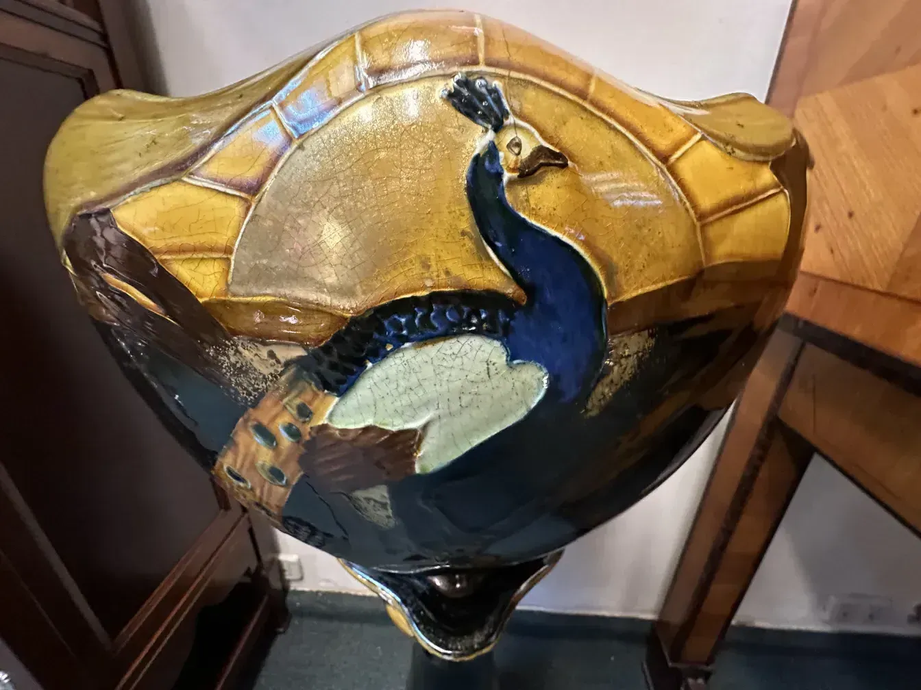 antique planter featuring colorful peacock and shiny details