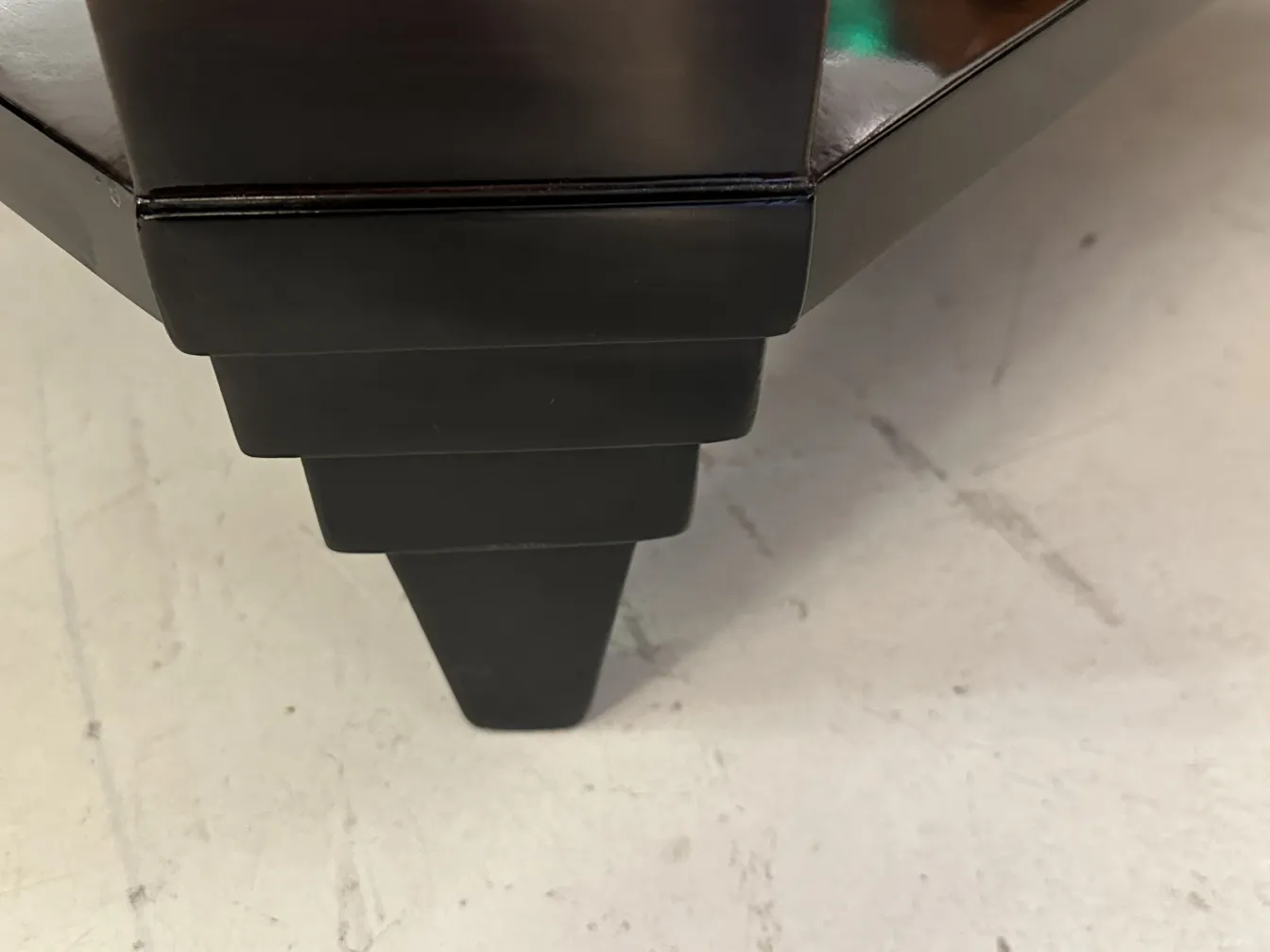 Antique coffee table with art deco details, sleek and stylish.