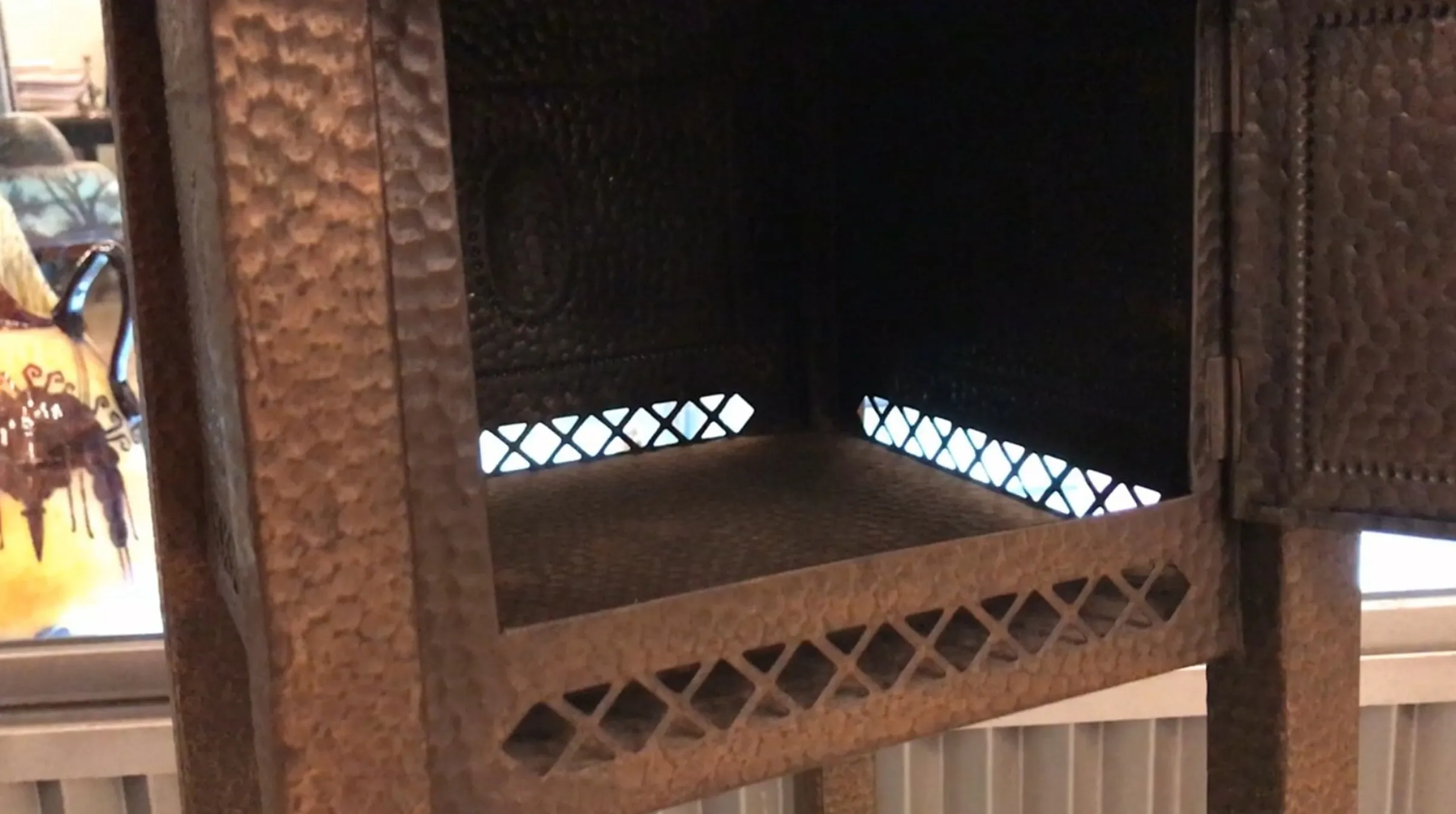 Antique small table with shelves, dark textured background