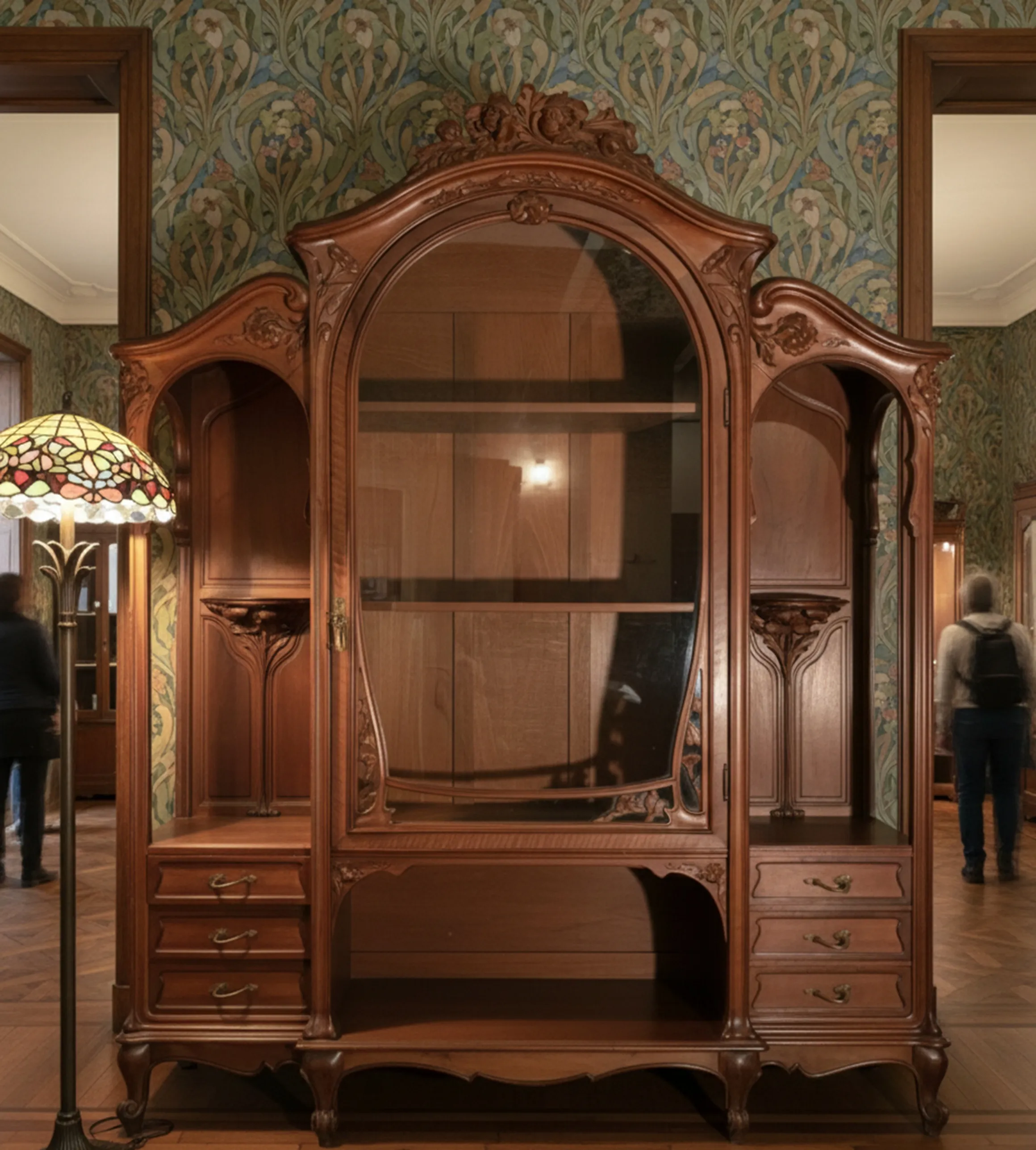 Antique E.Dienst display cabinet in an elegant setting with ornate details.