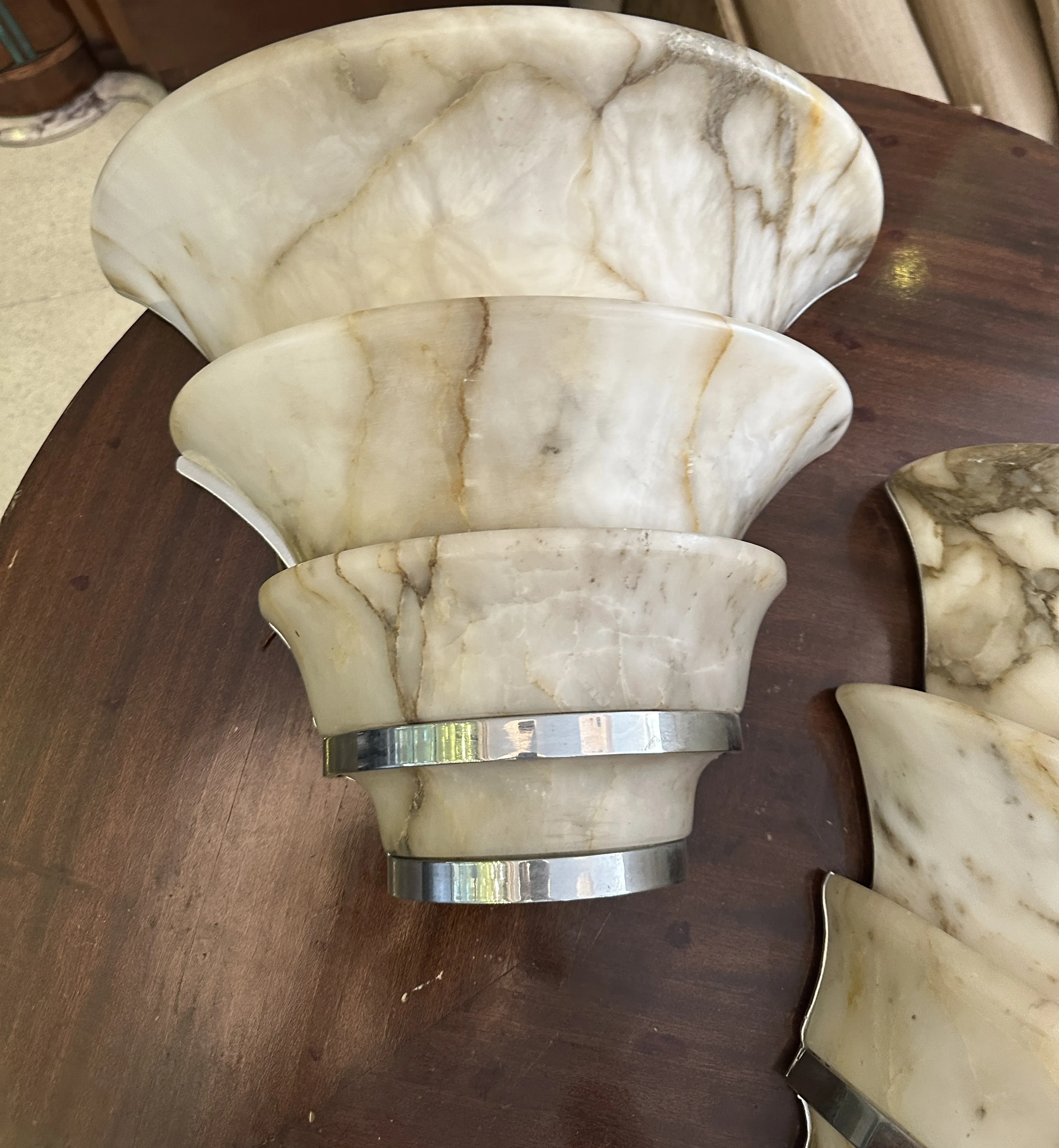 Antique pair of sconces with a unique design, perfect for vintage decor. The cozy ambiance enhances the classic style of any home.