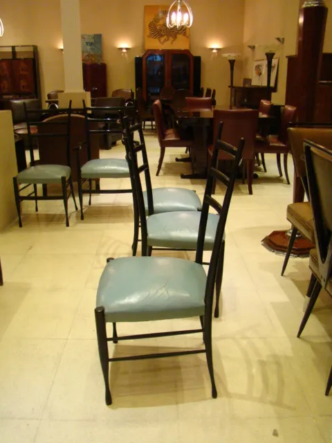 Antique rectangular dining table for 8 people, Gio Ponti, in an elegant setting with chairs.