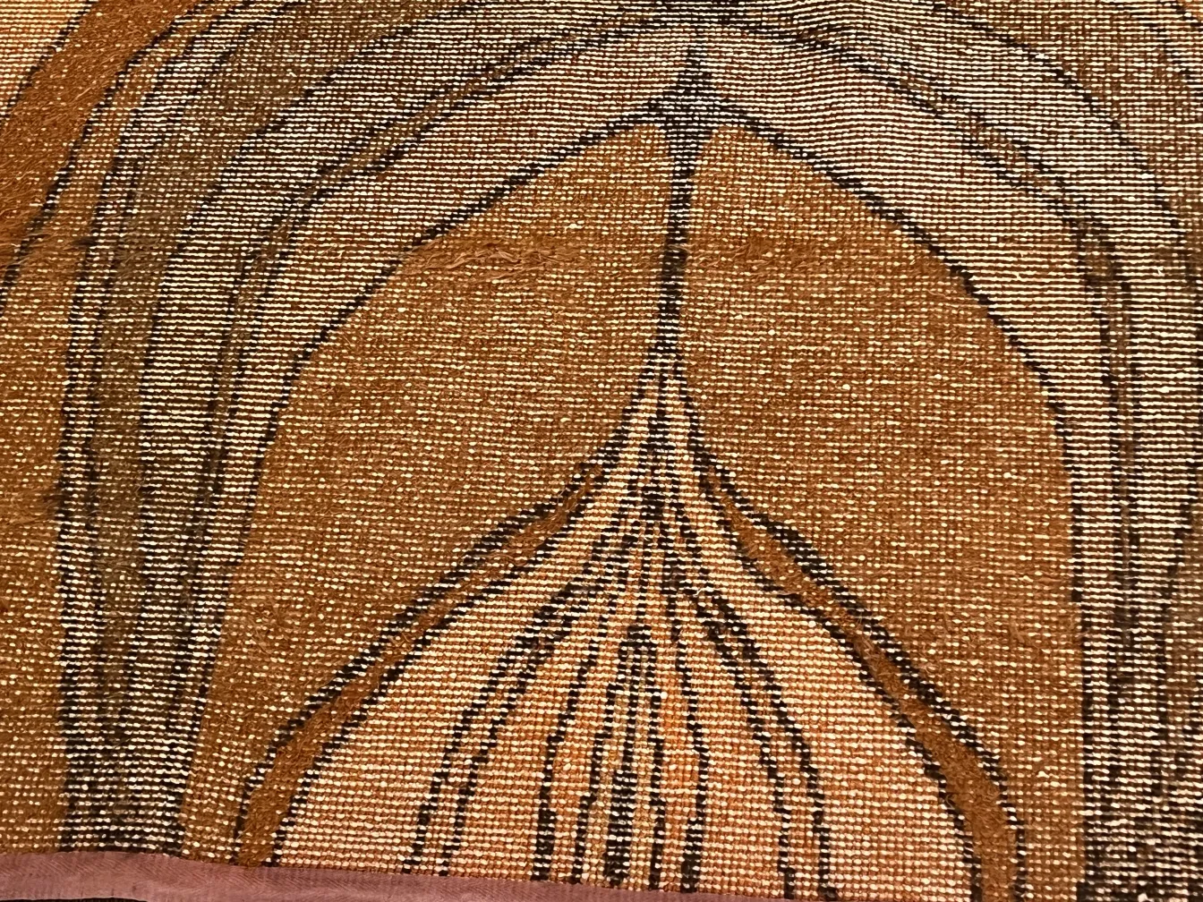 tappeto antico con design marrone e dettagli neri