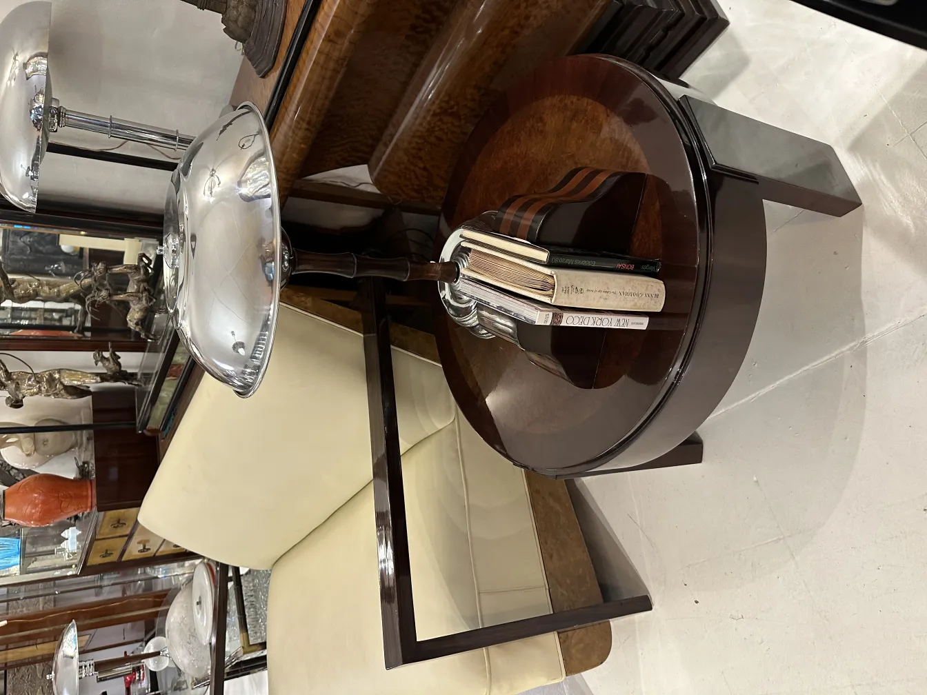 Antique bookends in wood, decorating a modern table. Includes an elegant setting with a metallic lamp.