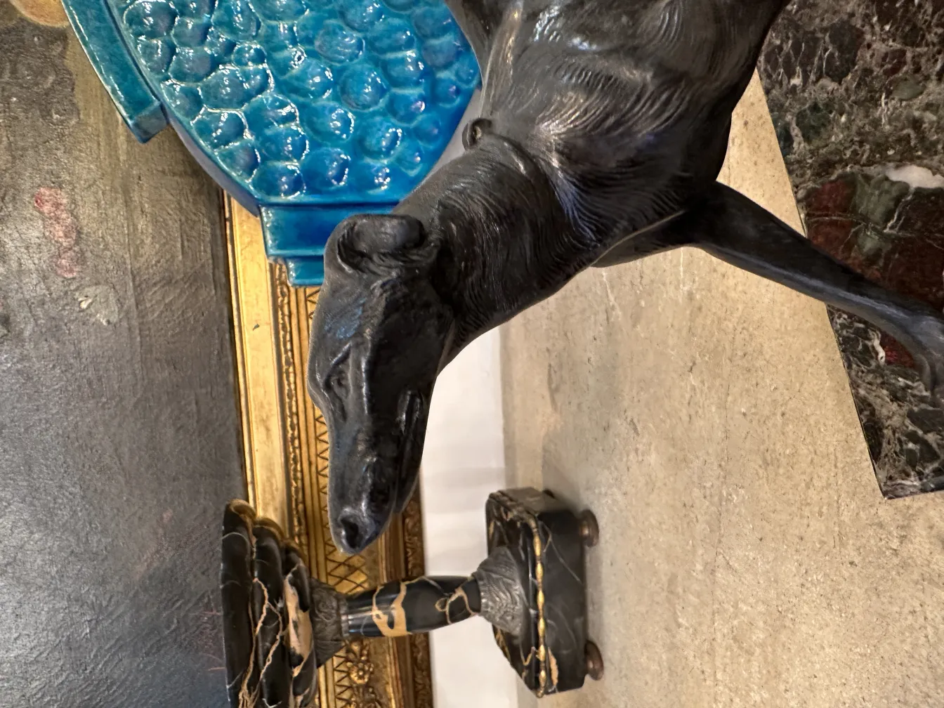 Antique bookends with dog figure and decorative background.