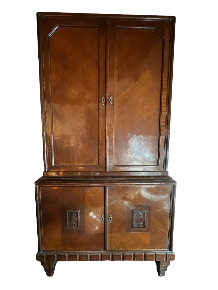 Antique bookcase with wooden doors in a bright setting.