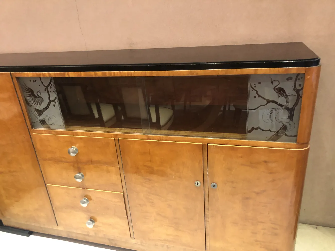 Antique bookcase featuring glass design and unique style.