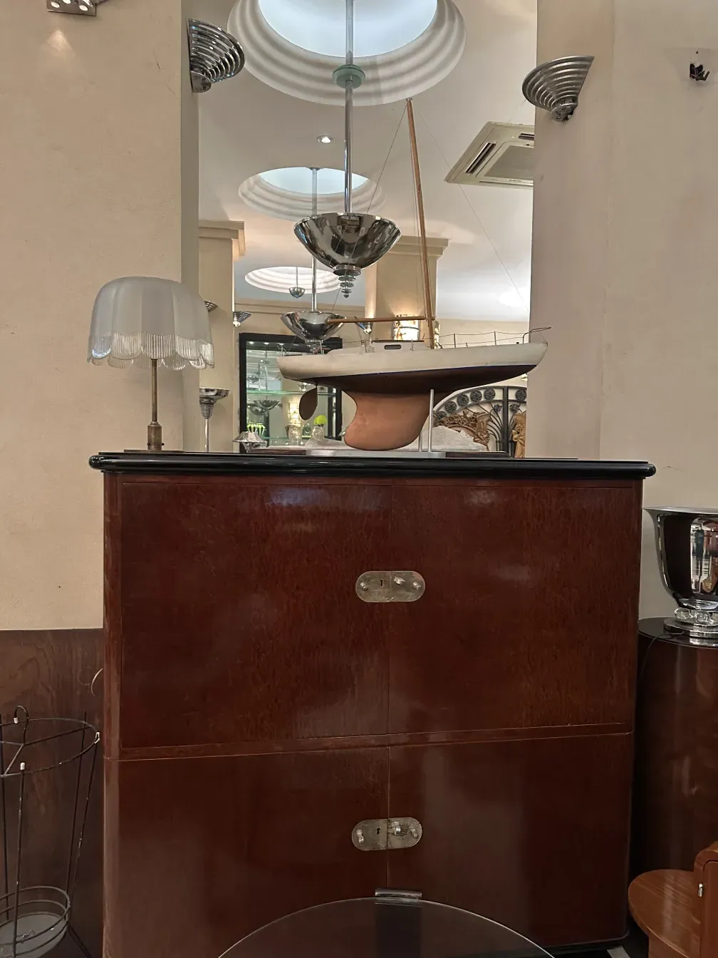 Antique bookcase featuring classic finishes and an elegant atmosphere. Decorative details and soft lighting.