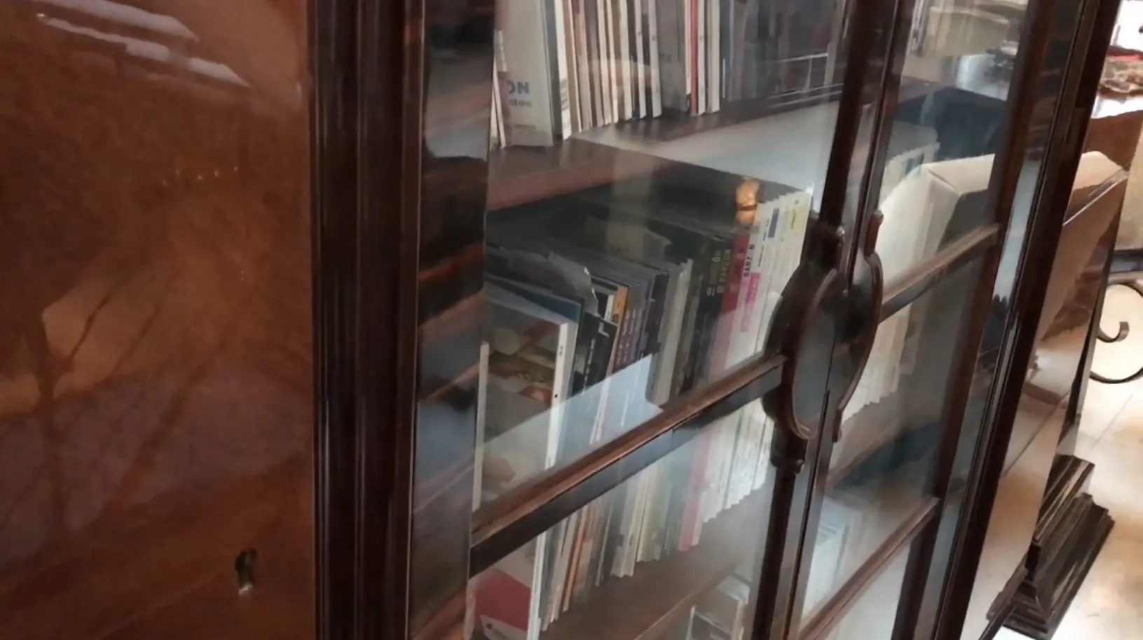 antique bookcase featuring an attractive design, shelves filled with books