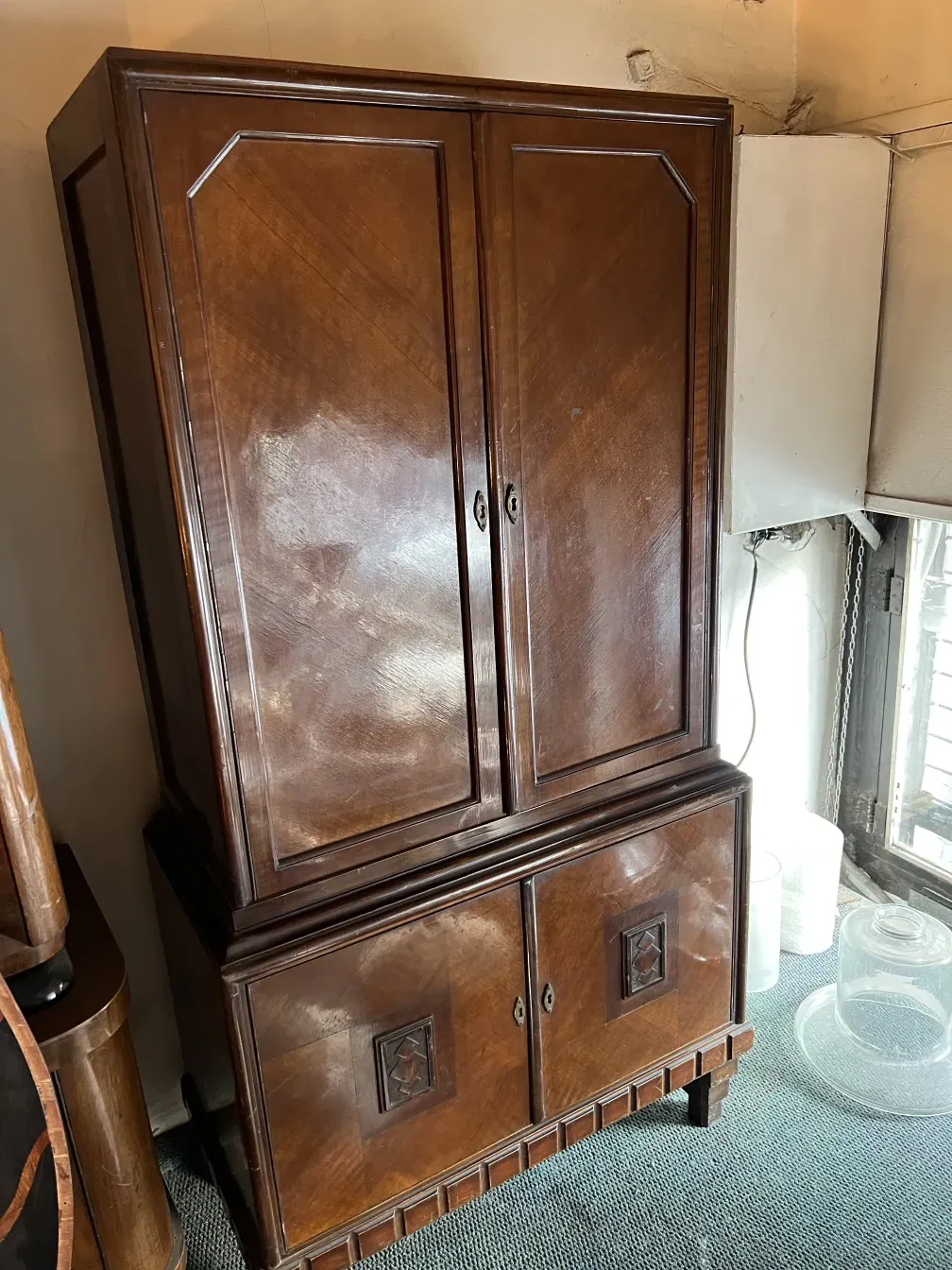 antique bookcase with decorative details and door