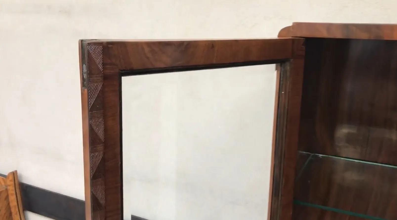 antique bookcase with glass shelves and ornate details